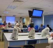 image: Pollen analysis workshop, benches, microscopes and large overhead display screens